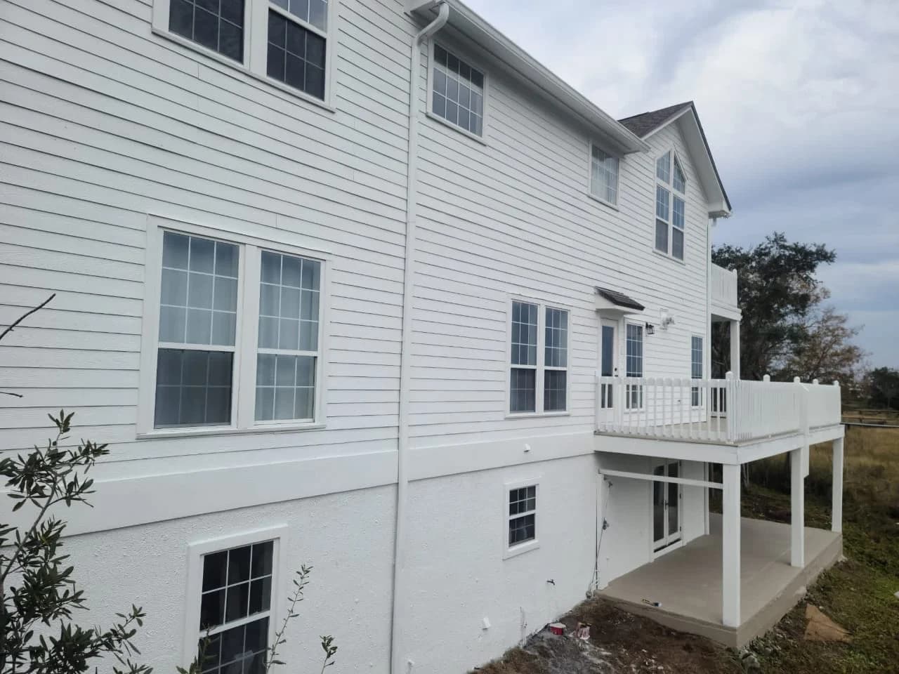 Two-story home with fresh exterior paint and balcony