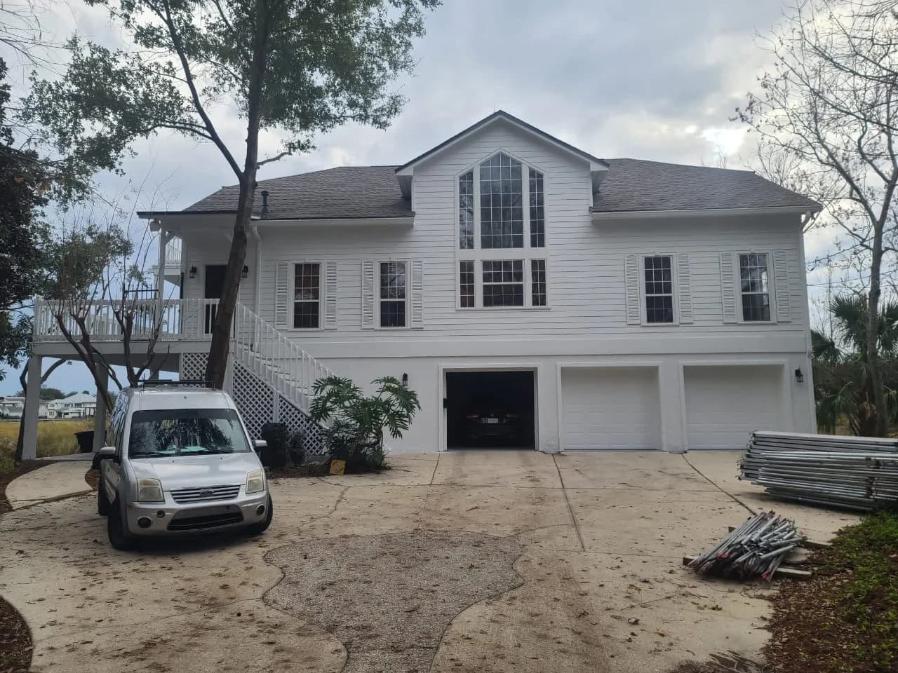 Waterfront home with white siding and fresh exterior paint